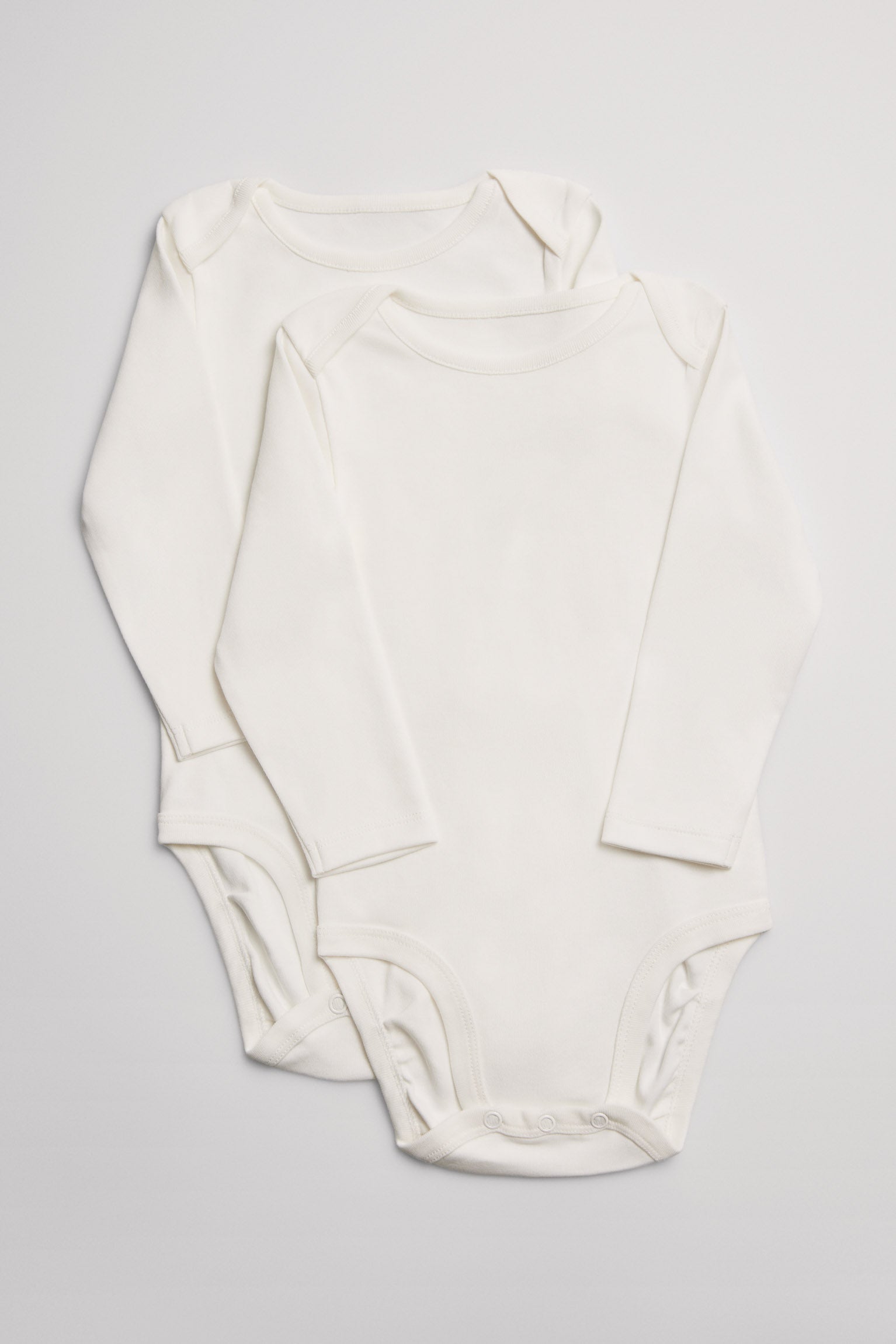 Pack 2 bodies bebé básicos manga larga solapas blancos