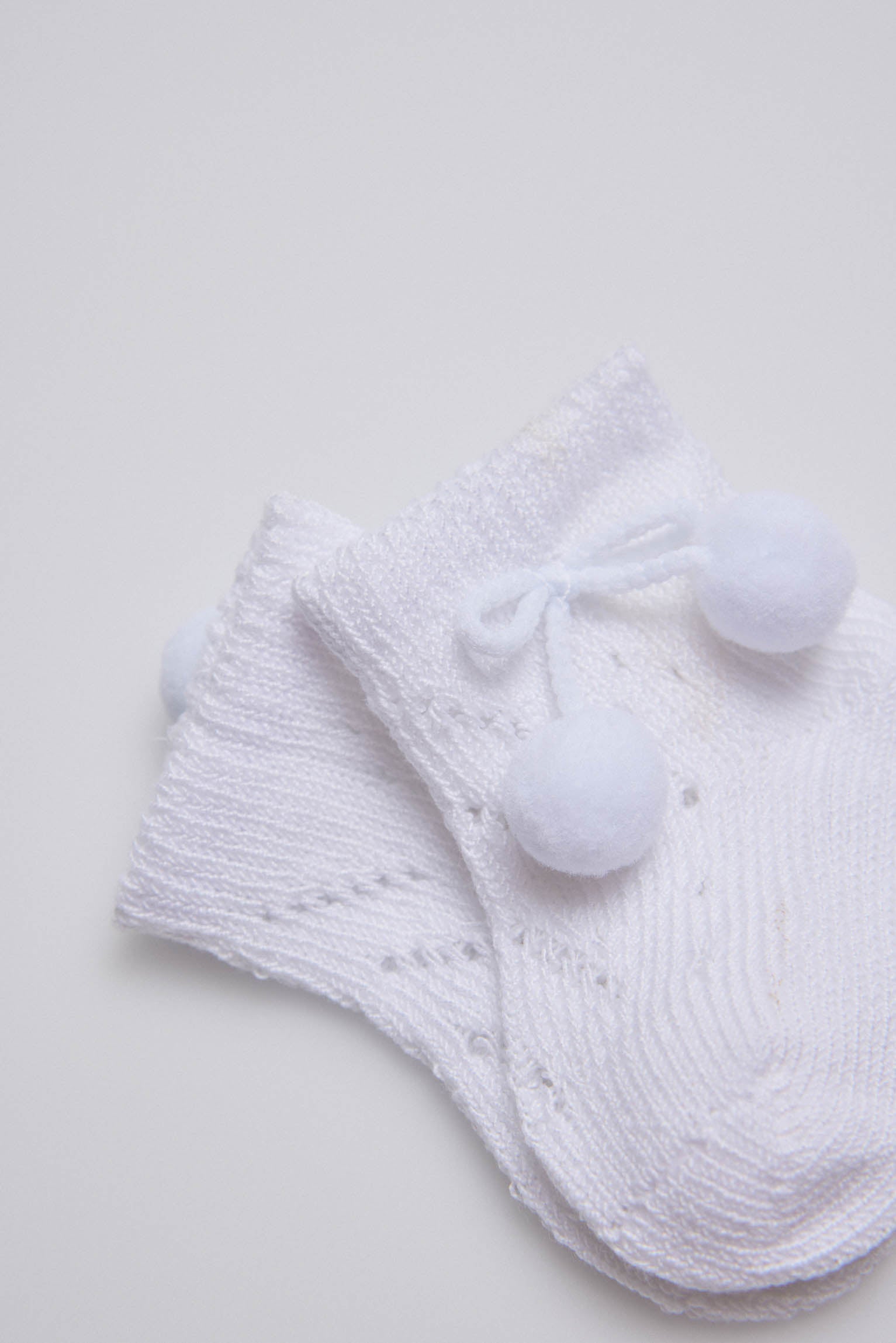Calcetines perlé con borlas recién nacido blanco
